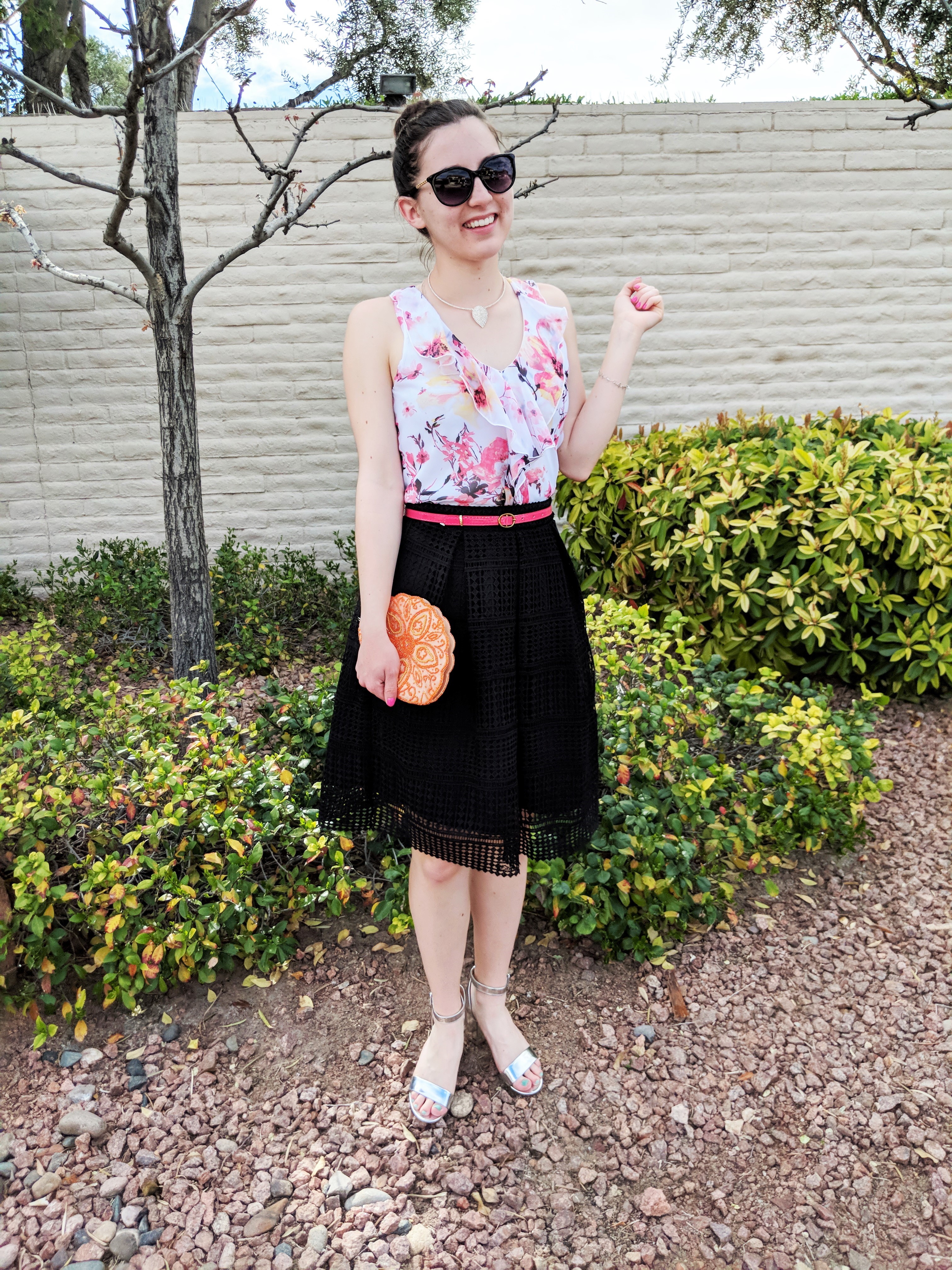 floral ruffle blouse, black skirt, pink belt, orange clutch, spring outfit