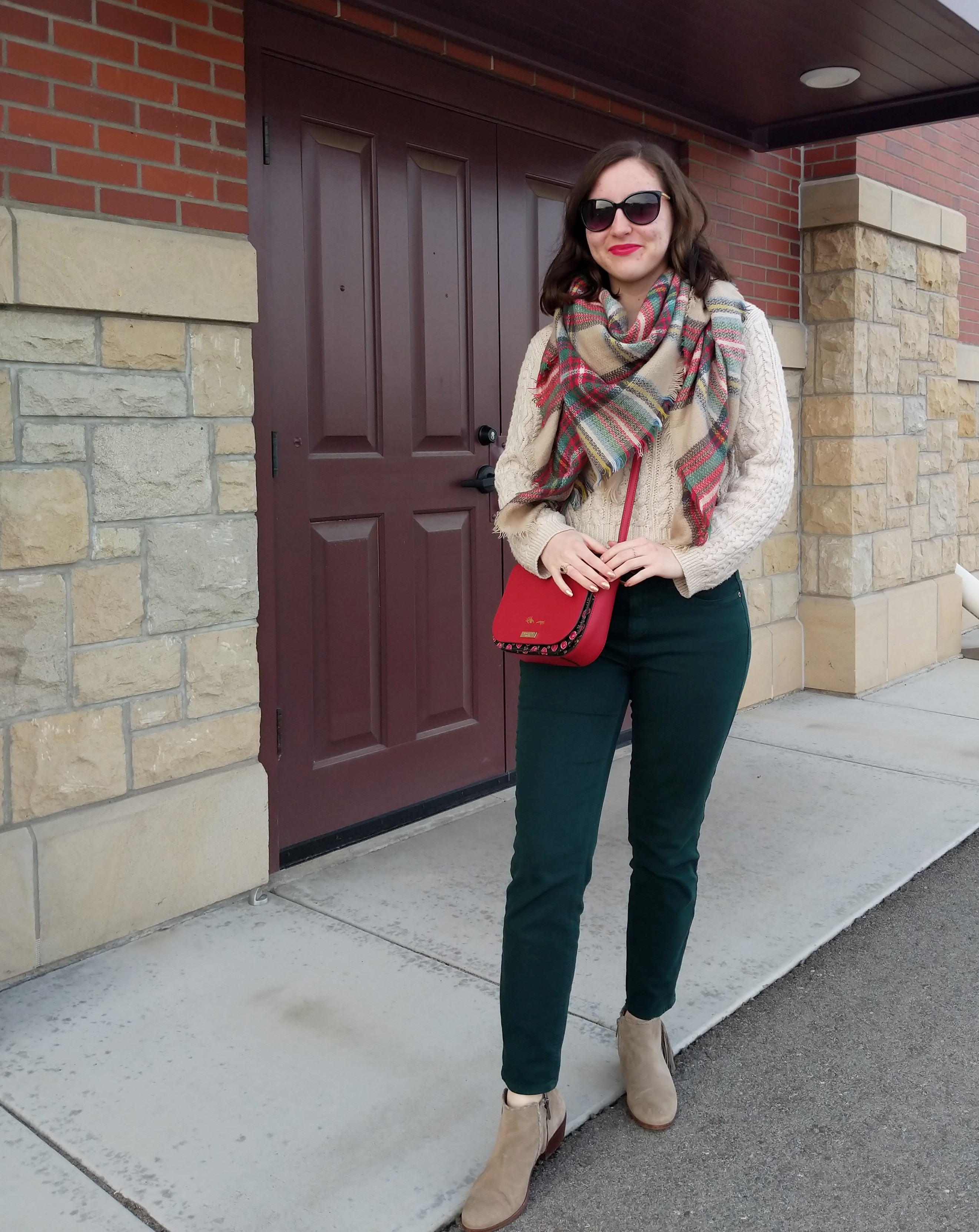 green pants red purse plaid blanket scarf