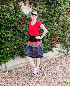 red shirt, patterned fair trade skirt, striped heels