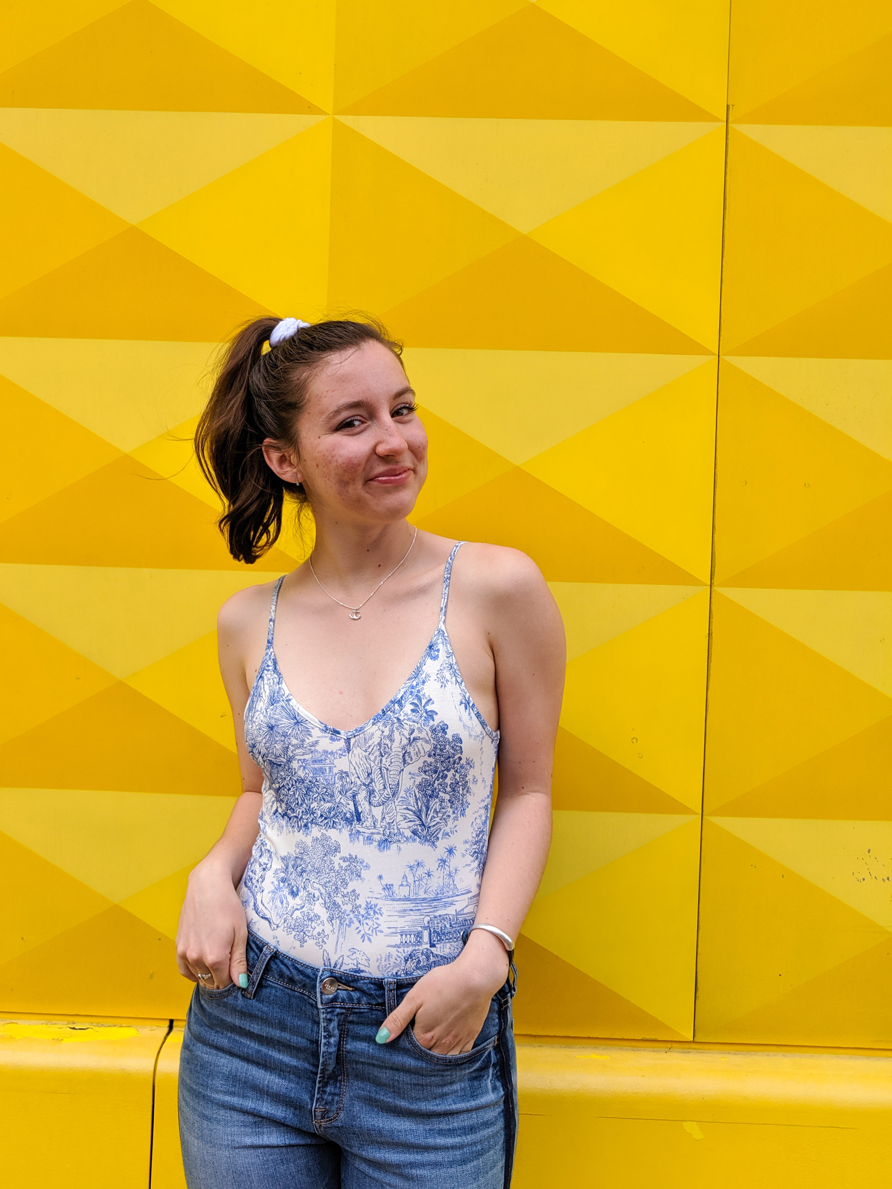 blue and white bodysuit, yellow background, blue and yellow