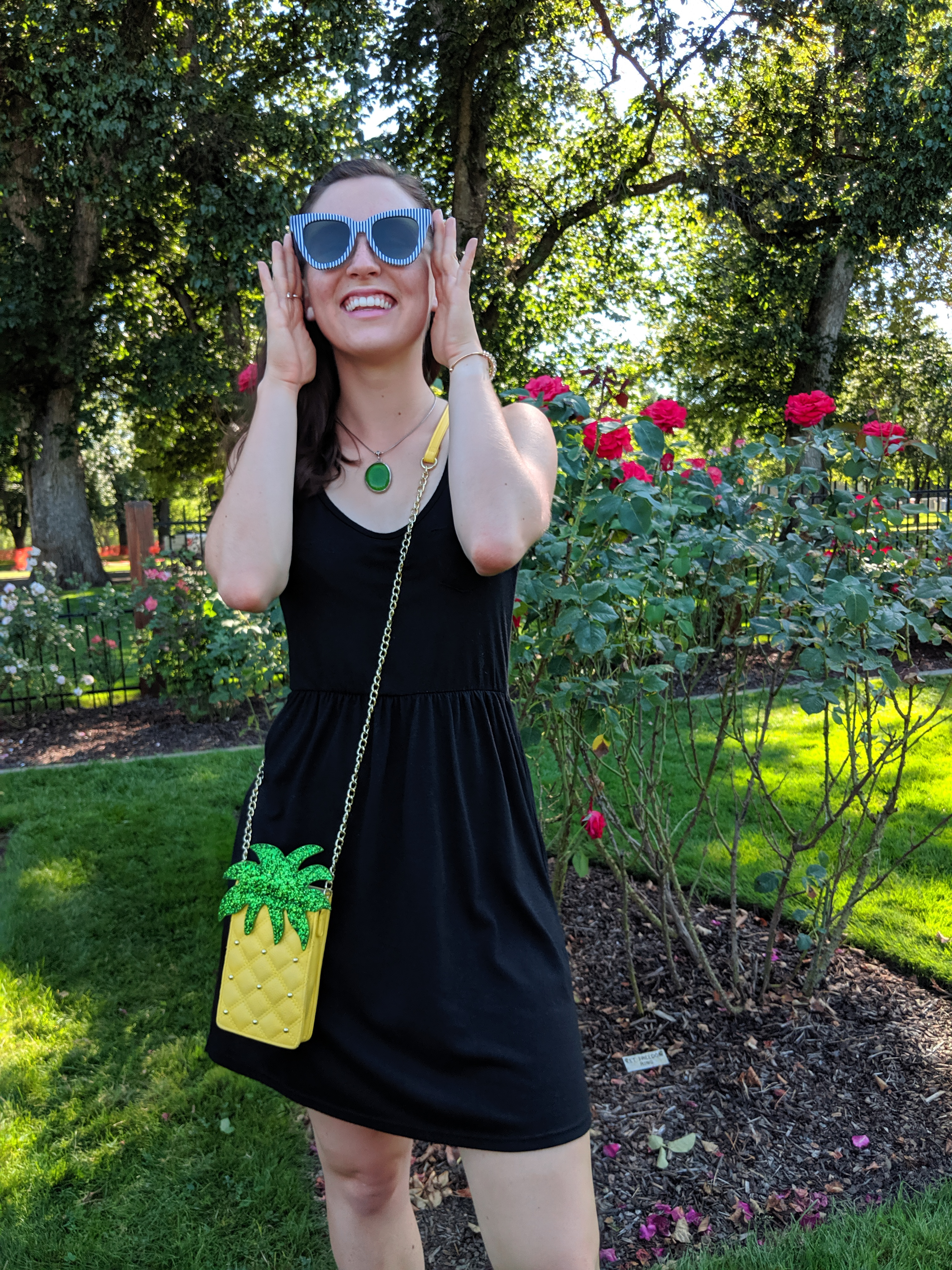 pineapple purse, green necklace, black dress