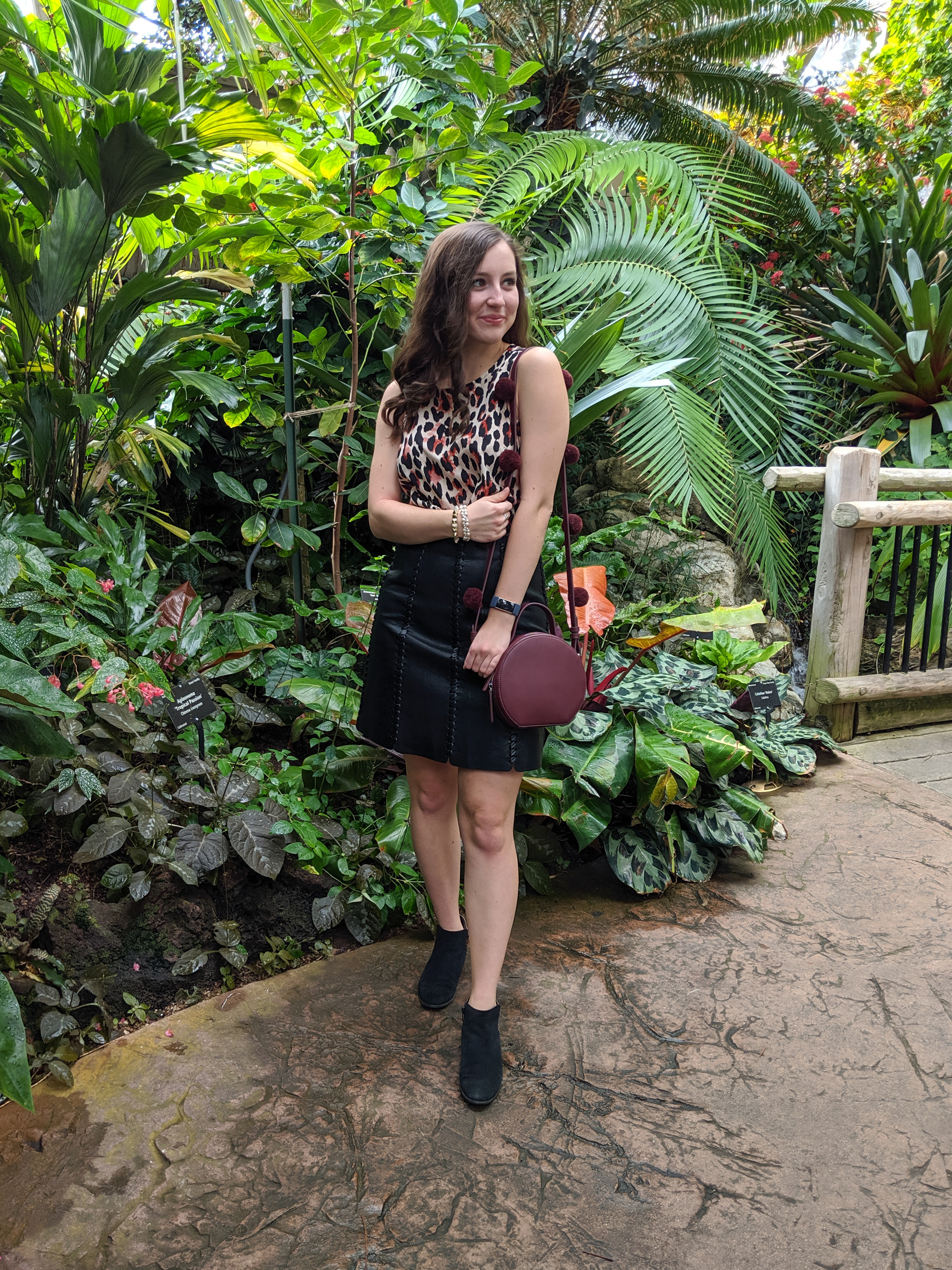 leopard dress, black leather skirt, burgundy purse, pom poms