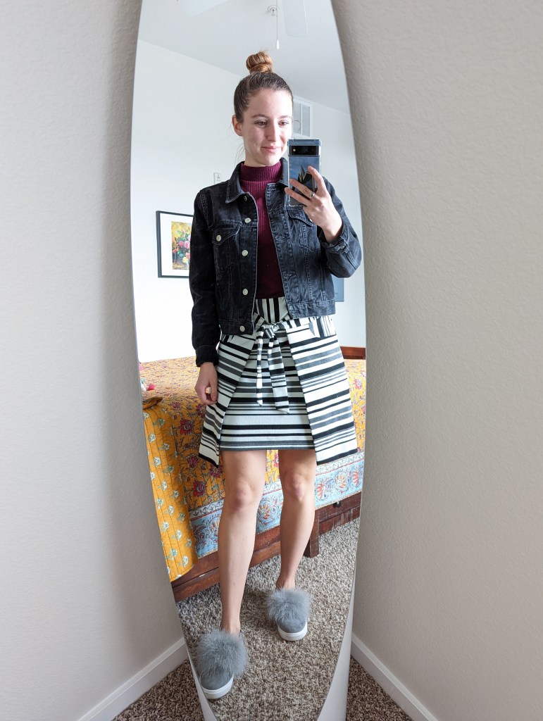 maroon-mock-neck-black-denim-jacket-striped-skirt-pom-pom-sneakers
