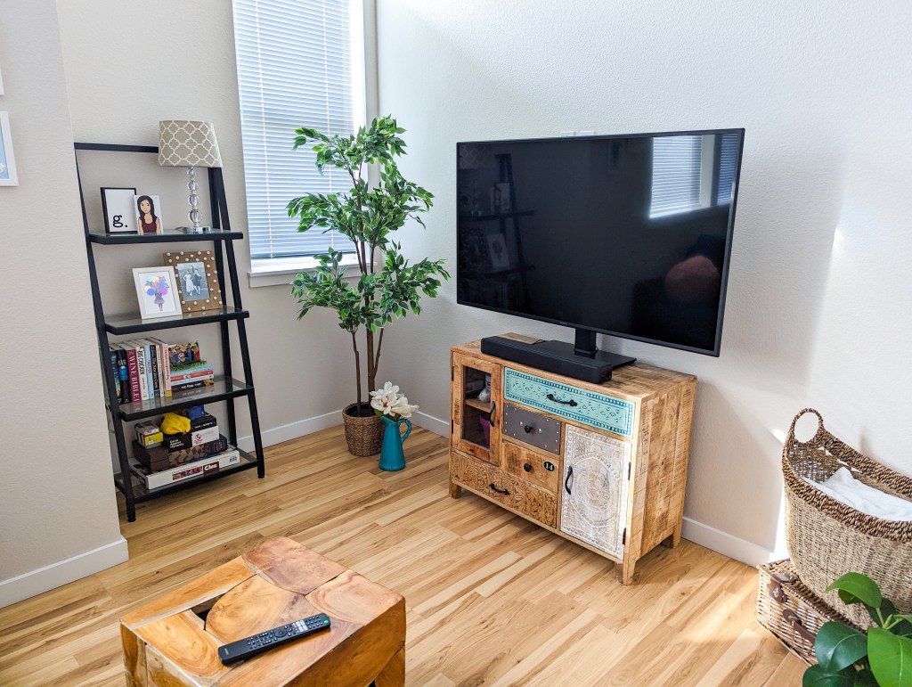 flat-screen-tv-shabby-chic-apartment-bookshelf-fake-tree-ikea