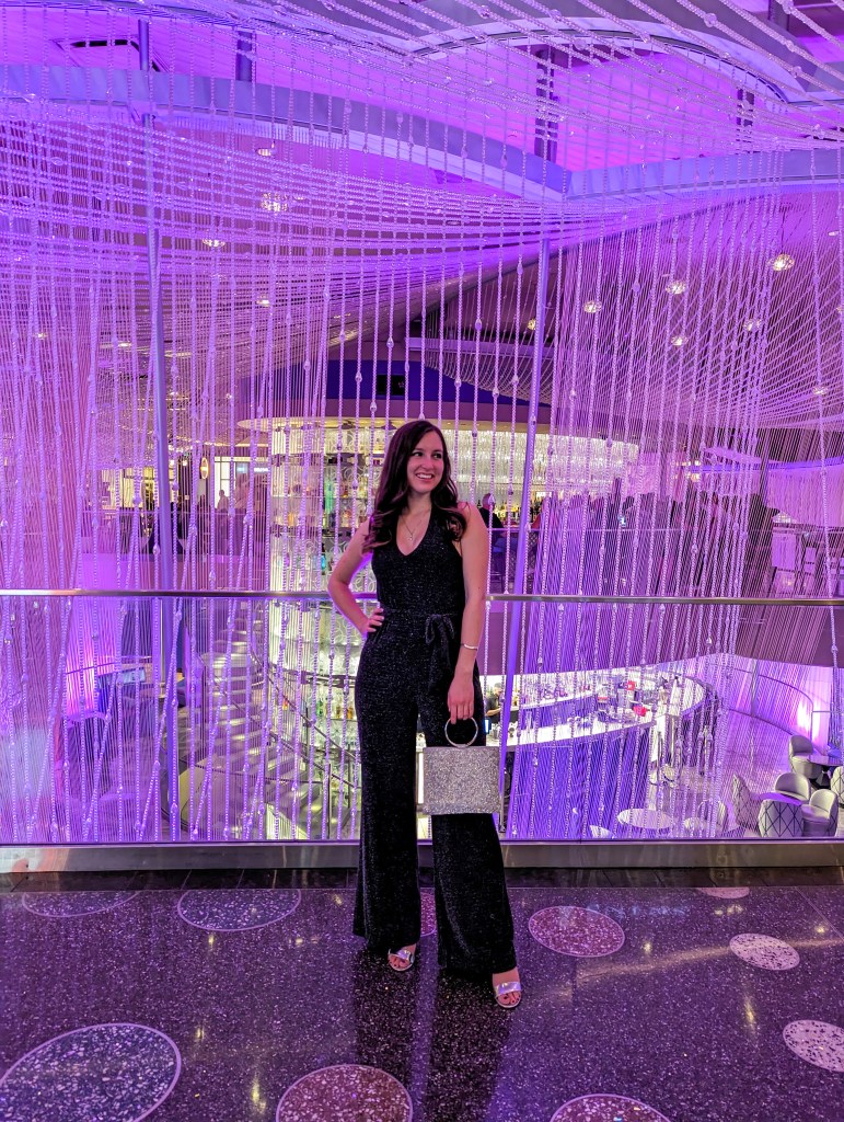 black-sparkly-jumpsuit-chandelier-bar-cosmopolitan-hotel-silver-purse-heels